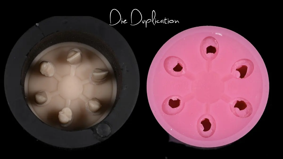 A duplication ring with dies beside the silicone mold it leaves